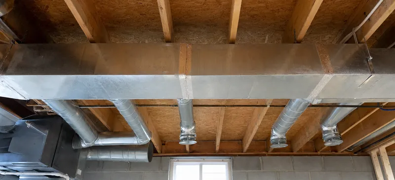 Supply trunk duct and branch ducts in a basement