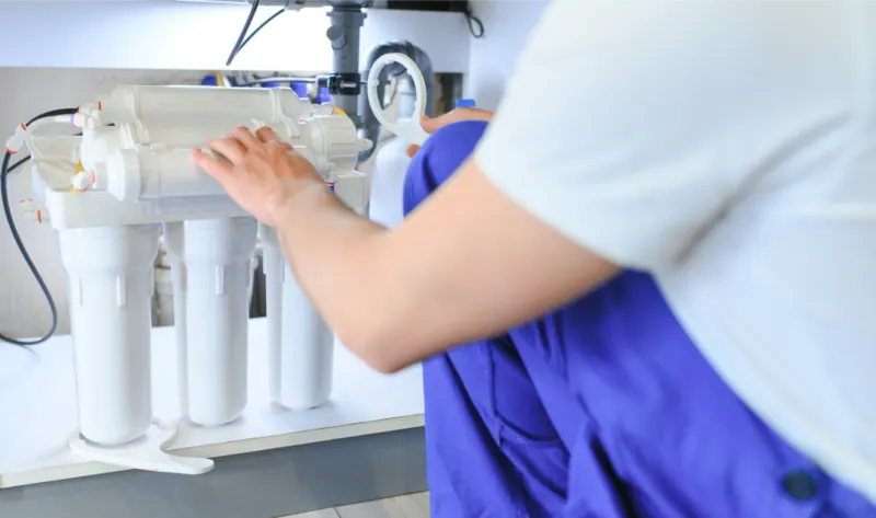 Technician installing a reverse osmosis water filter