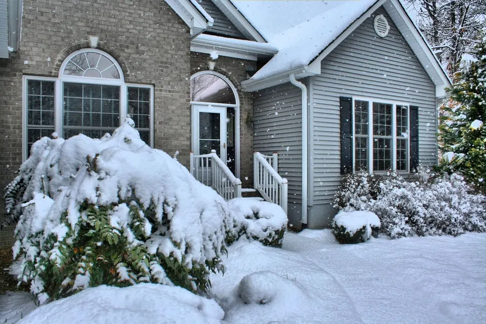 Snow-covered house and front steps in winter